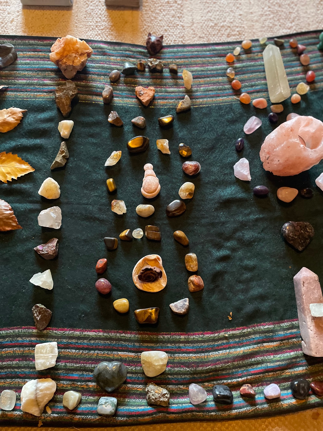 A crystal grid laid in a spiral on dark cloth