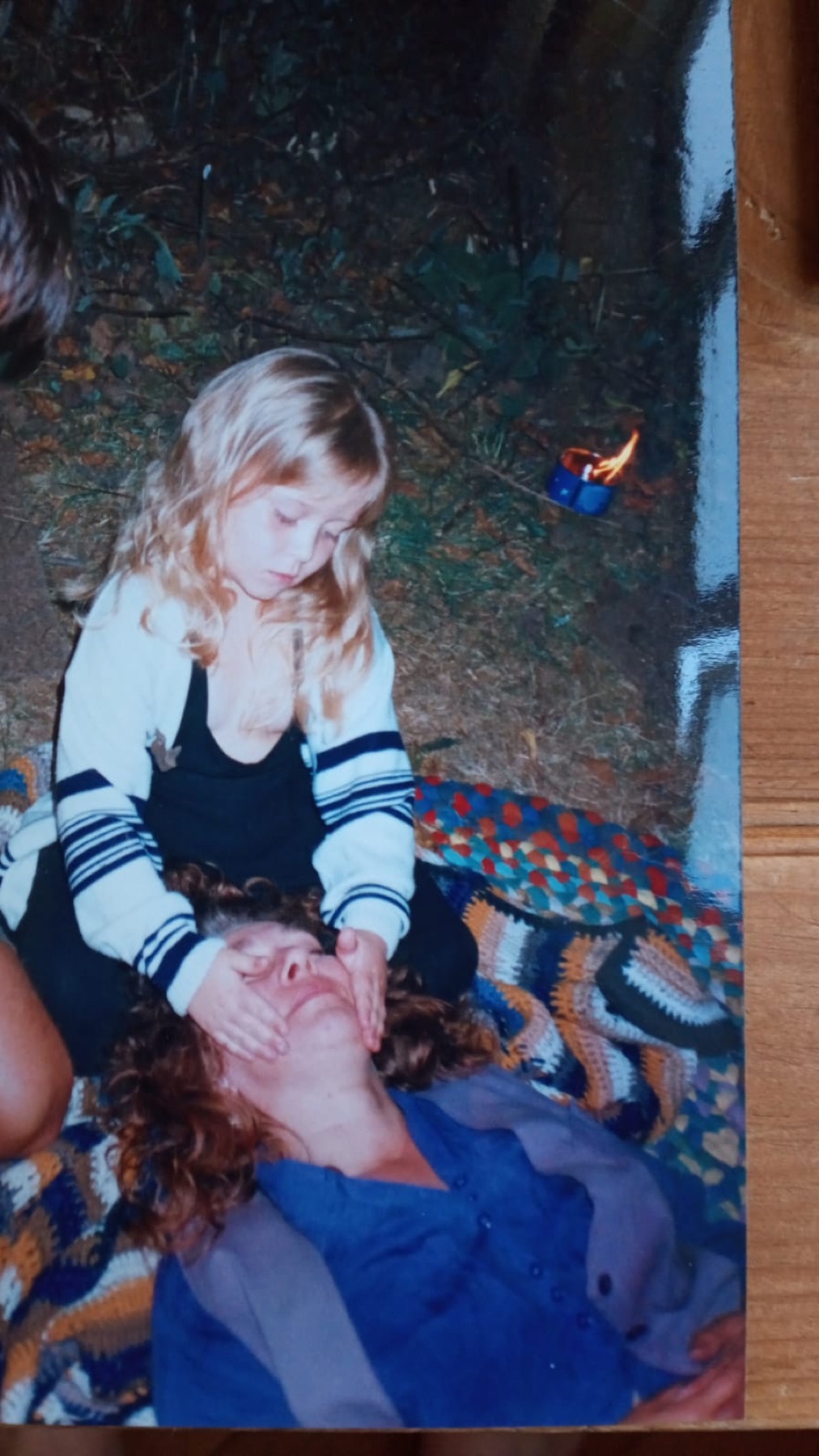 Jade as a small child with her hands on her grandmother's face