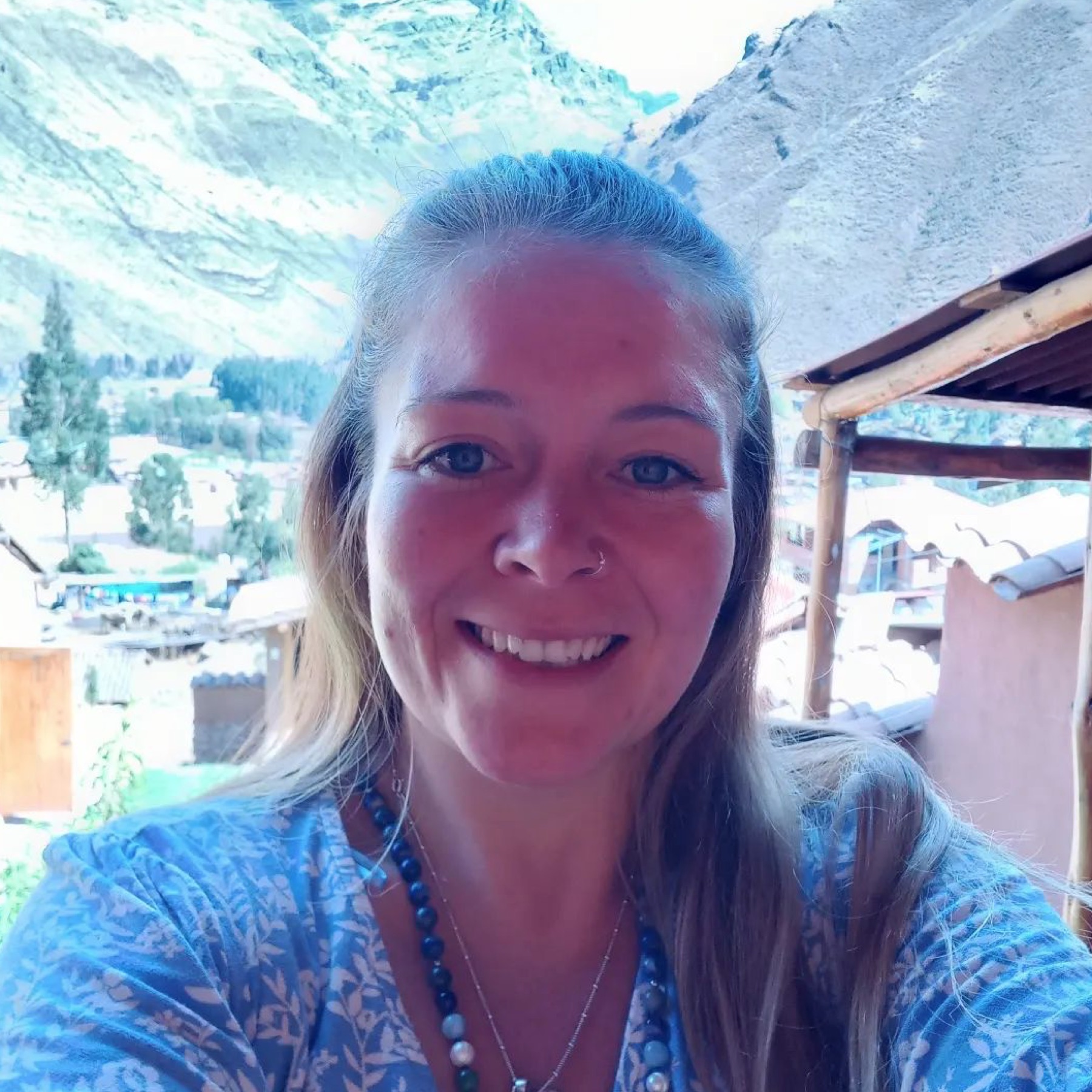 Jade smiling in front of mountains and rooftops in Peru